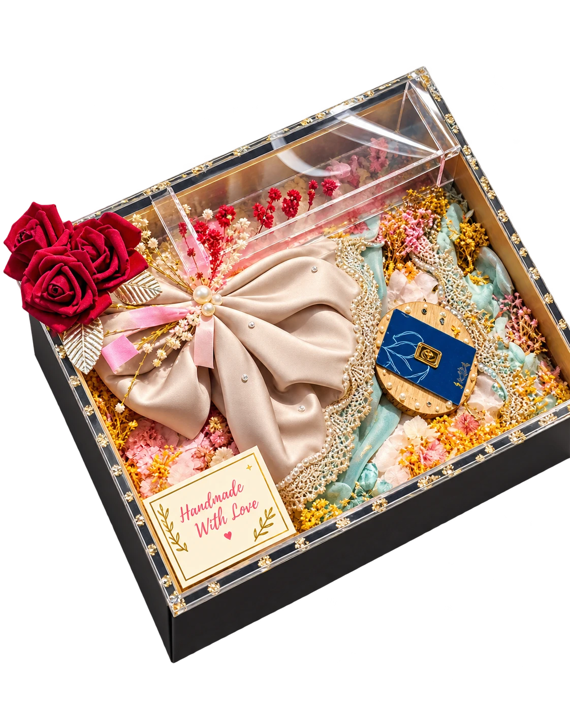 Black trousseau box with a clear acrylic lid, a satin bow bundle, dried flowers and red roses