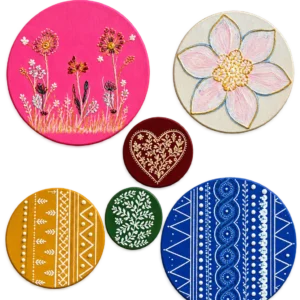 Set of six hand-painted round wall art pieces in pink, cream, maroon, mustard, green and blue