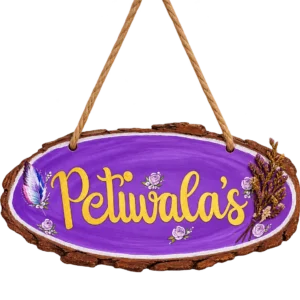 Purple wood slice nameplate with gold lettering, a painted feather and dried lavender