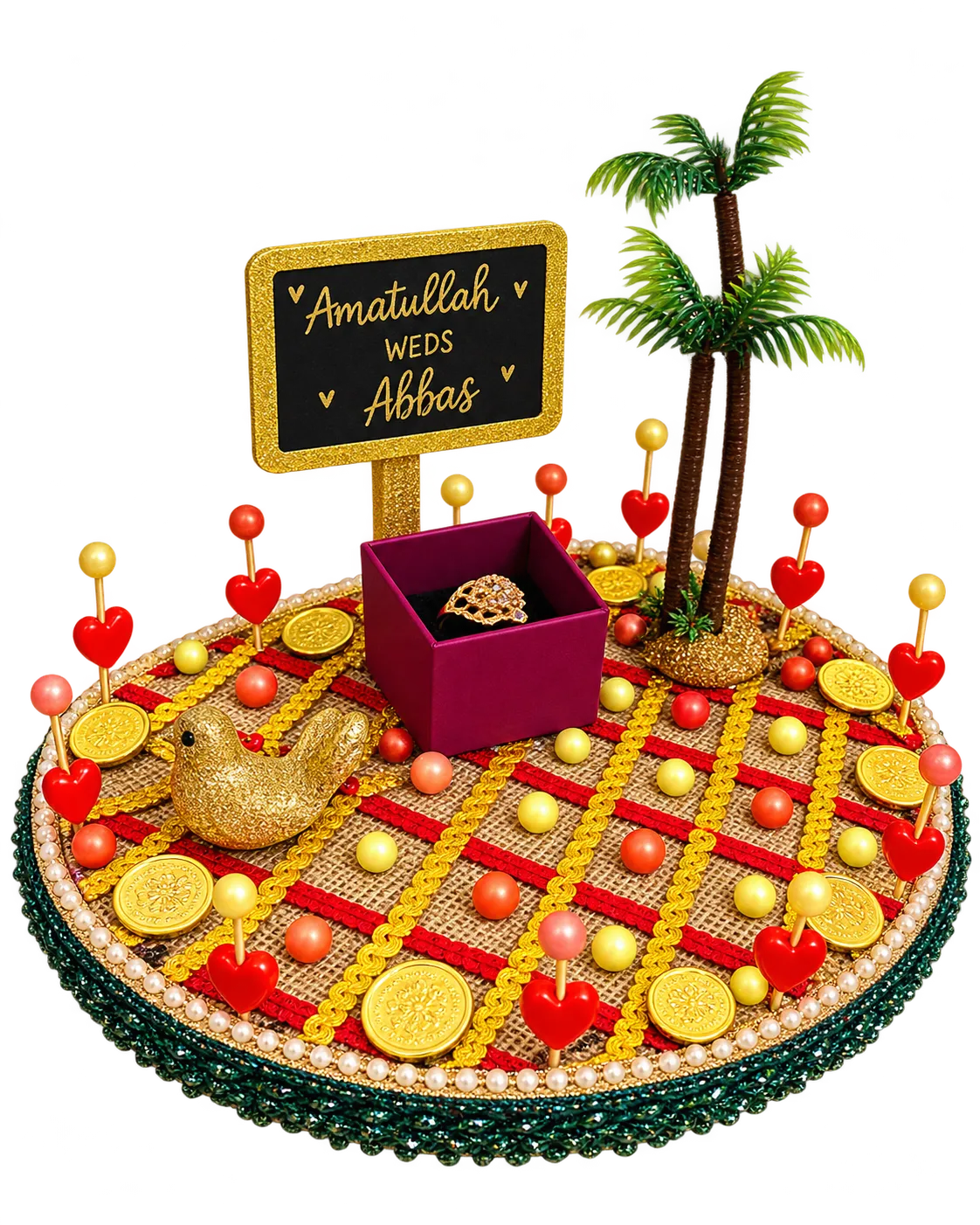 Round jute ring tray with red and gold trims, gold coins, a palm tree, a gold bird, heart picks, a ring box and a name board