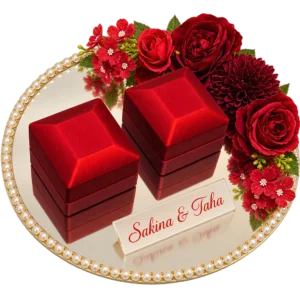 Round mirror ring tray with a pearl border, two red ring boxes, red flowers and an acrylic name plaque