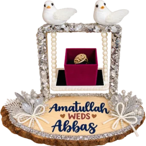 Silver sequin swing ring stand with two white doves, pearl ropes, a ring box and a wood slice name base