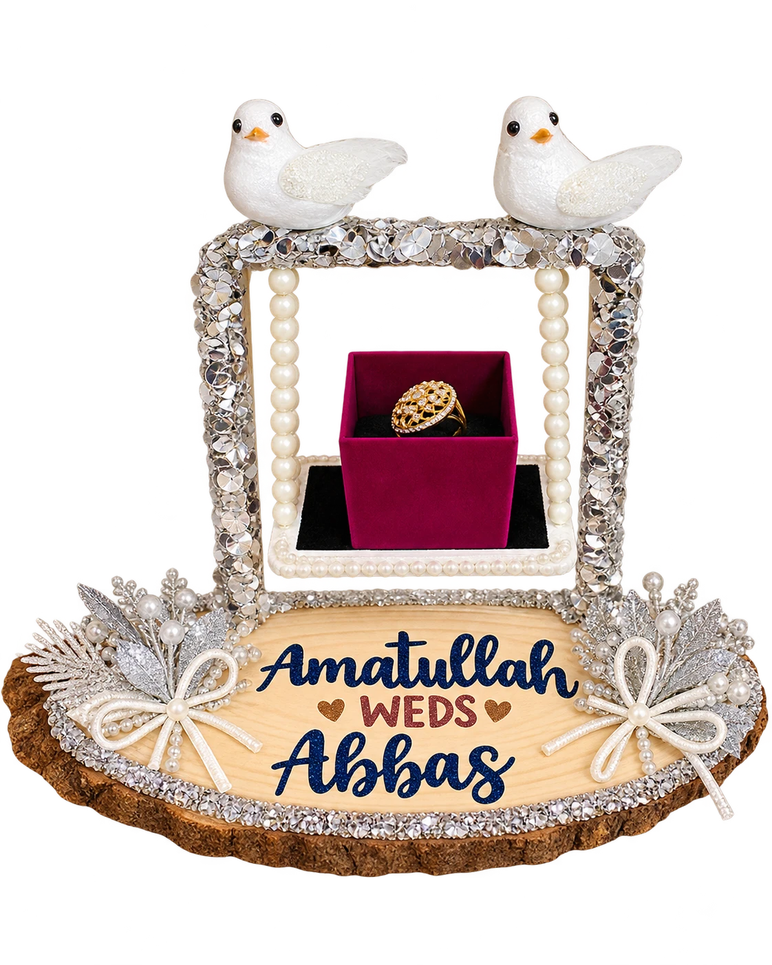 Silver sequin swing ring stand with two white doves, pearl ropes, a ring box and a wood slice name base